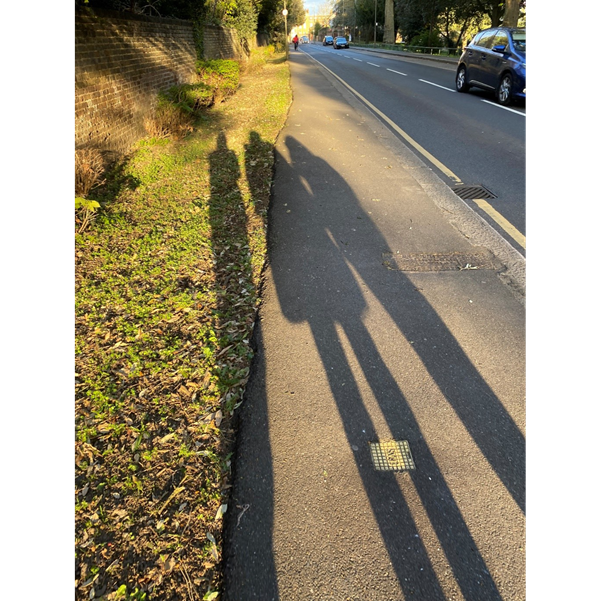 the shadow of three women on the pavement
