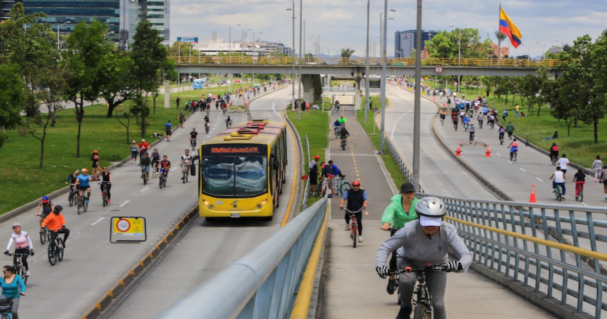 a road with people walking and cycling on it in Columbia