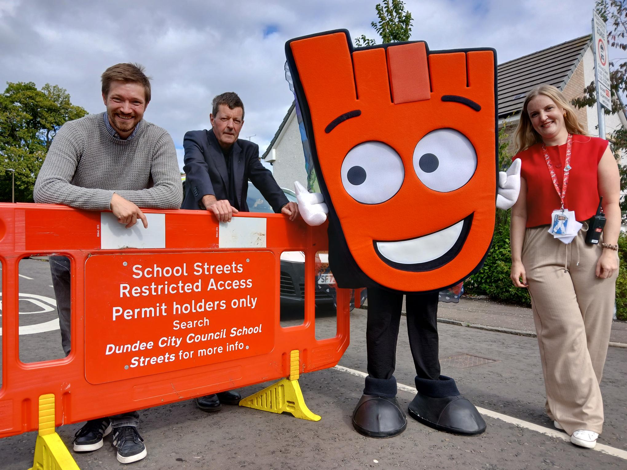 Councillors Steven Rome and Willie Sawers with Living Streets' mascot, Strider, and a teacher from Mill of Mains Primary School