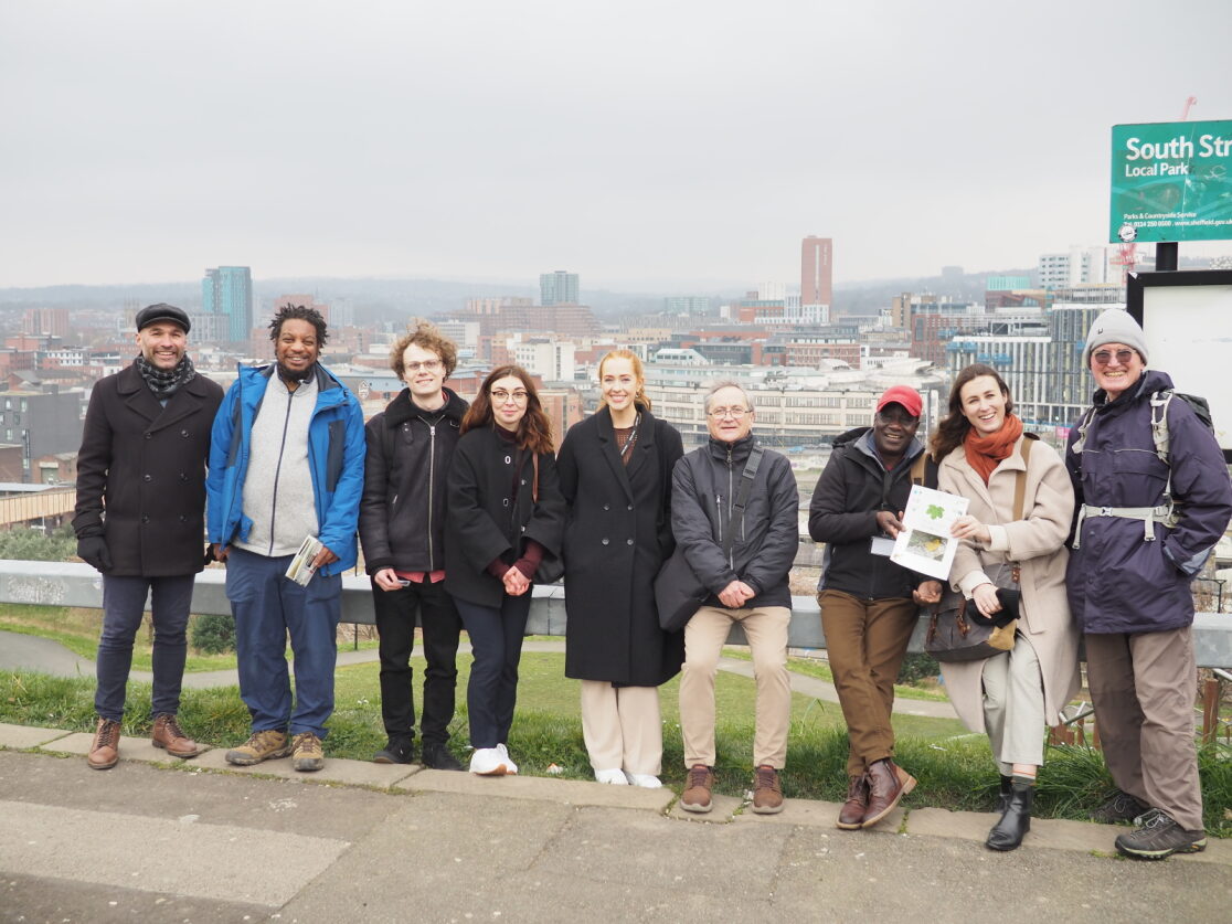 a group of people standing with sheffield city centre in the background