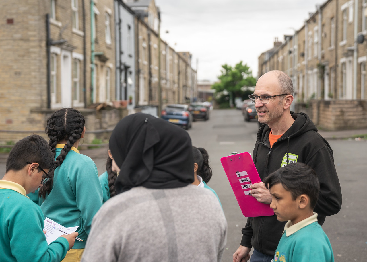 Photograph of a street audit taking place with school pupils and a member of Living Streets staff.