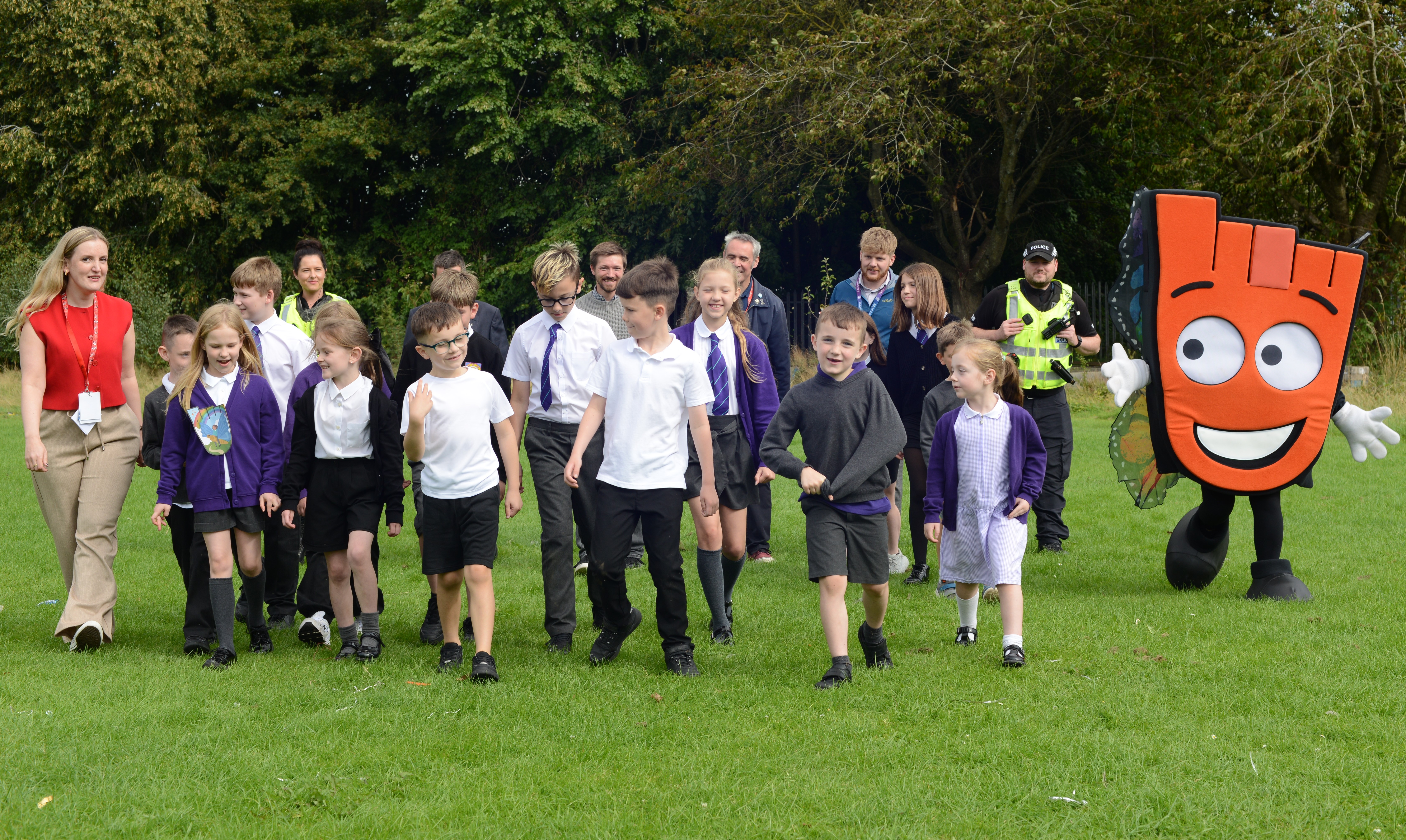 Pupils from Mill of Mains Primary School walking with Living Streets' mascot, Strider